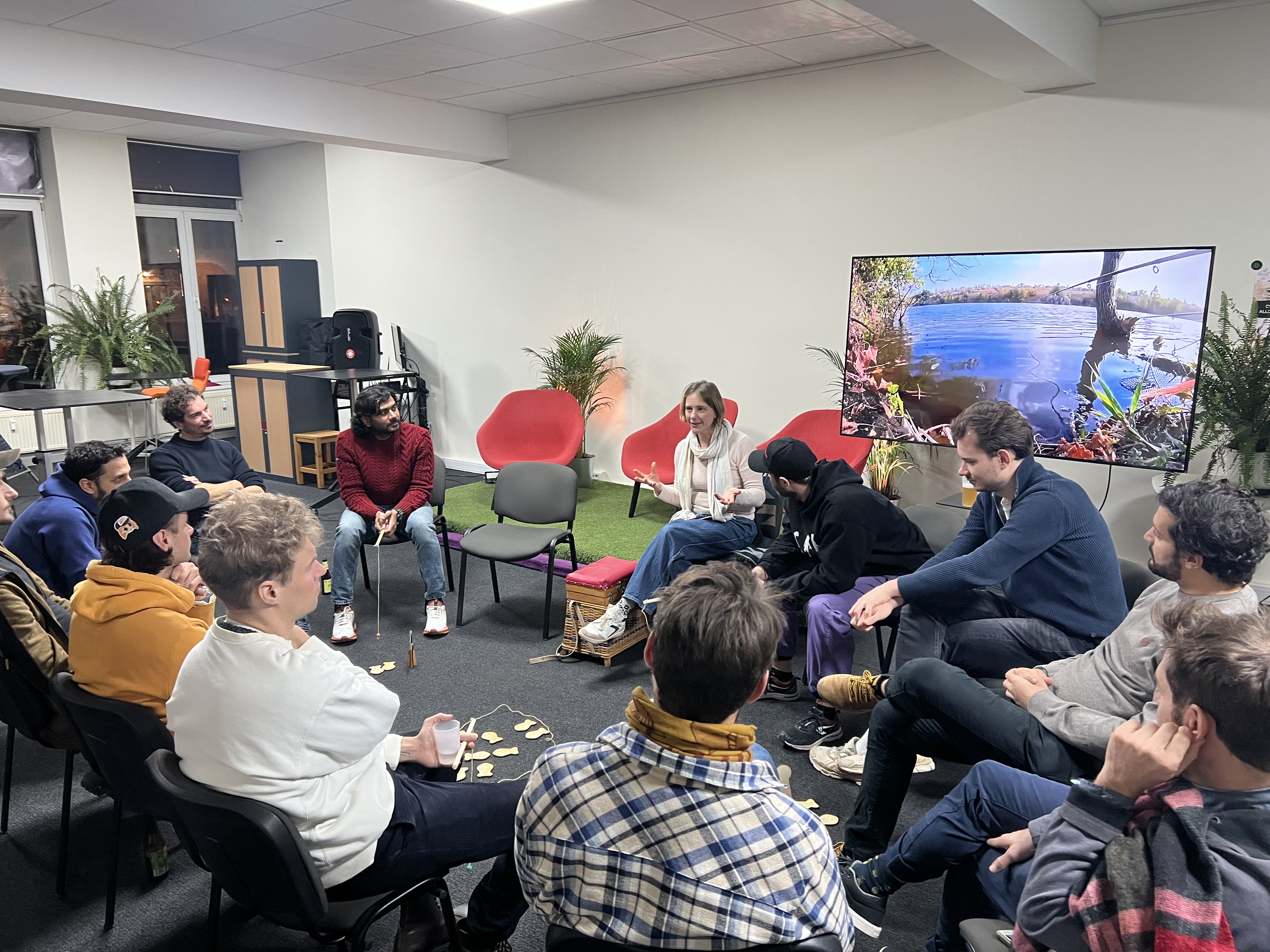 The Commons Game workshop in action - participants sitting in a circle discussing